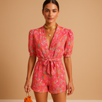 Short printed summer jumpsuit for women in pink and purple with belt and tailored fit, perfect for warm days and stylish outings.