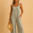Women’s summer jumpsuit with high waist, wide legs, and button details. Lightweight and breathable design, perfect for casual or evening looks.
